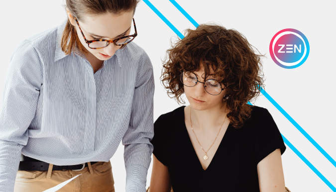 Two women reviewing paper documents 