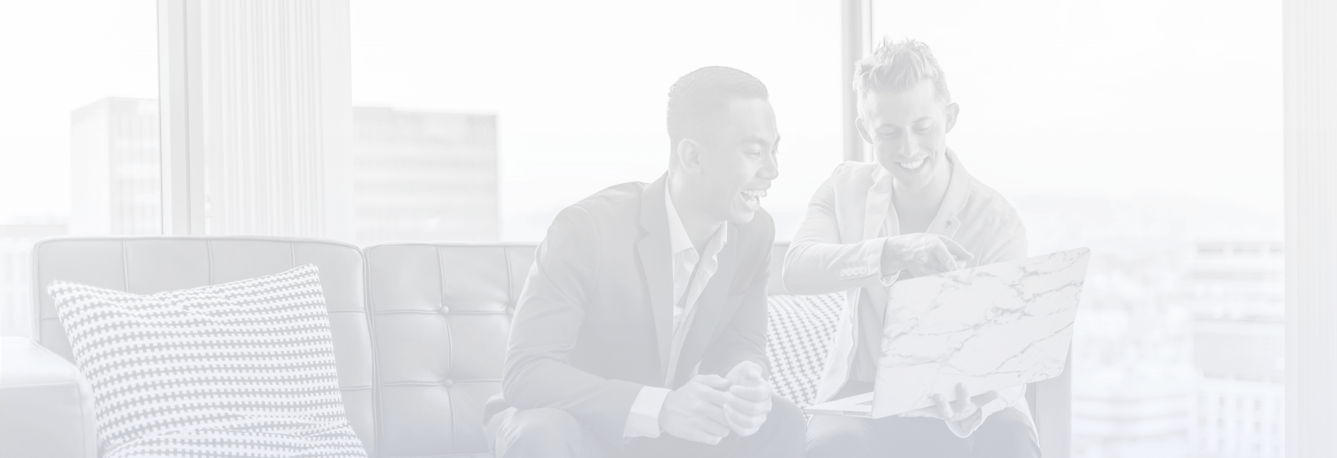 Background image of two business men pointing at a computer monitor