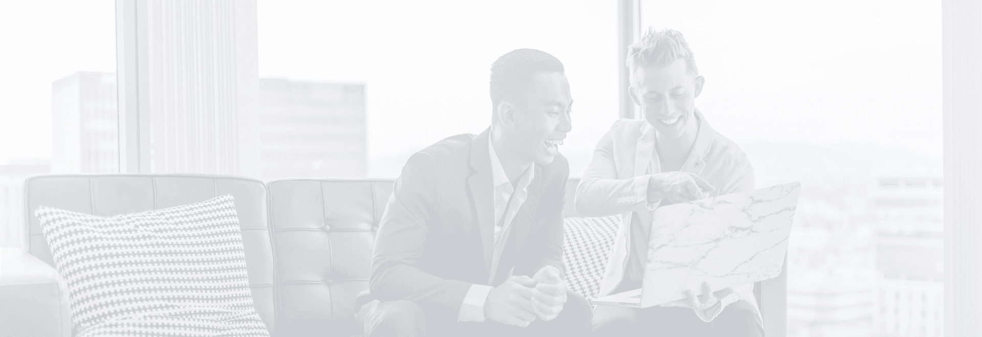 Background image of two business men pointing at a computer monitor