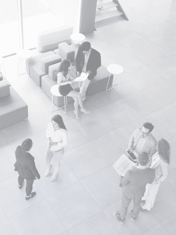 Background image of employees walking through a hallway, aeriyal view.