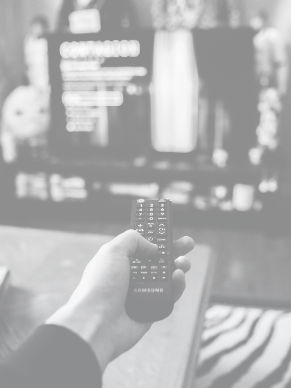 Background image of person clicking a remote.