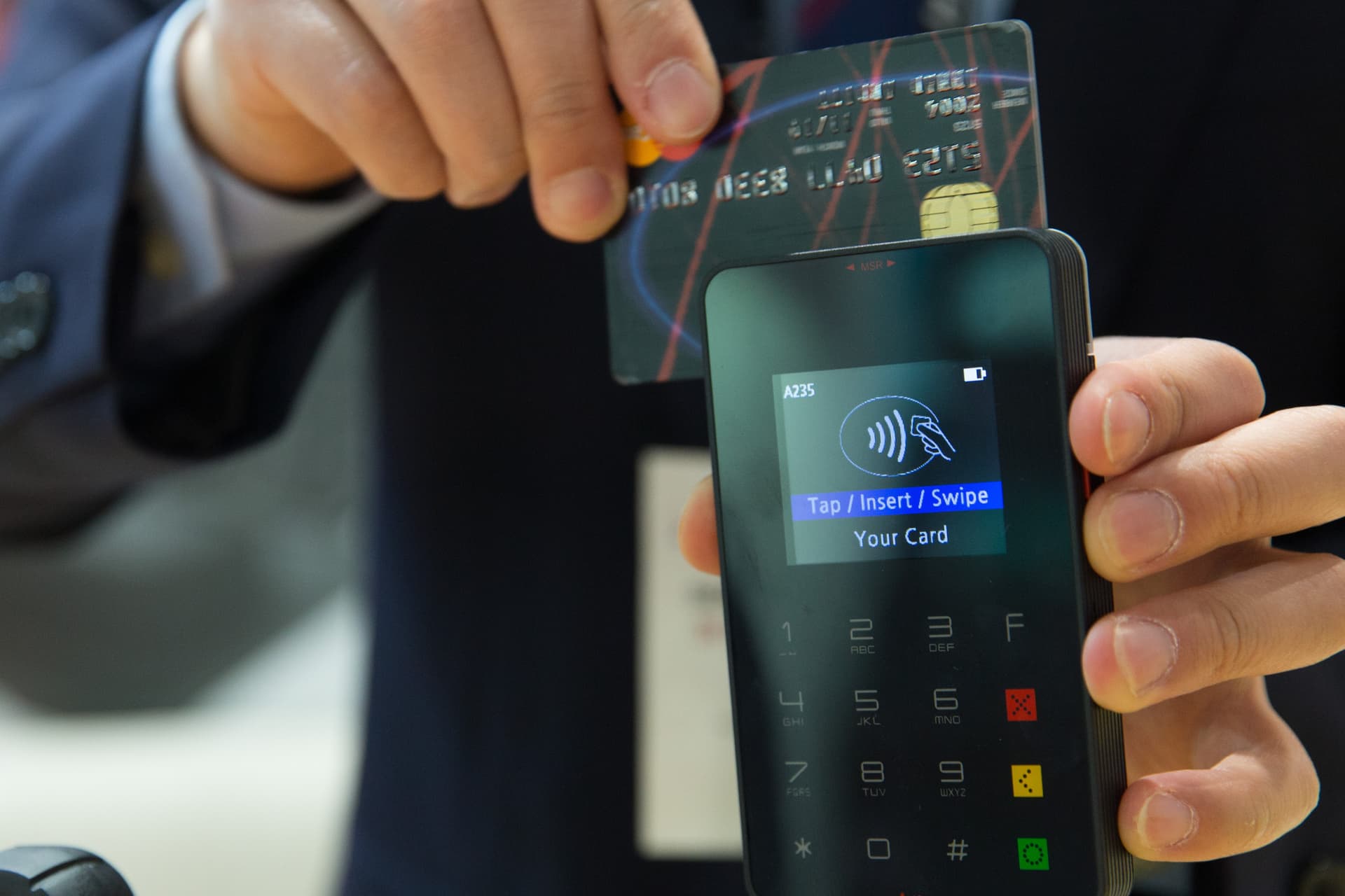 Credit card being swiped at a payment terminal
