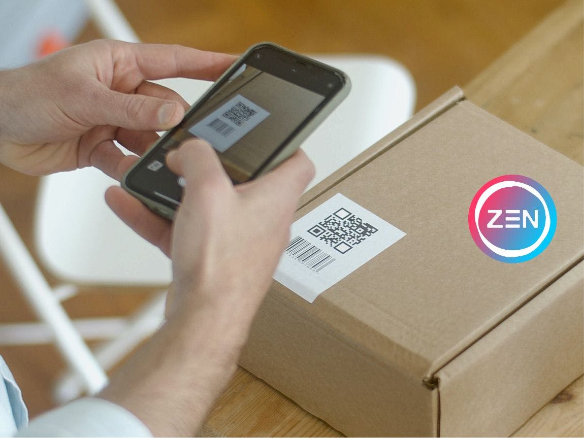 Person scanning a shipping label on a package with a cell phone